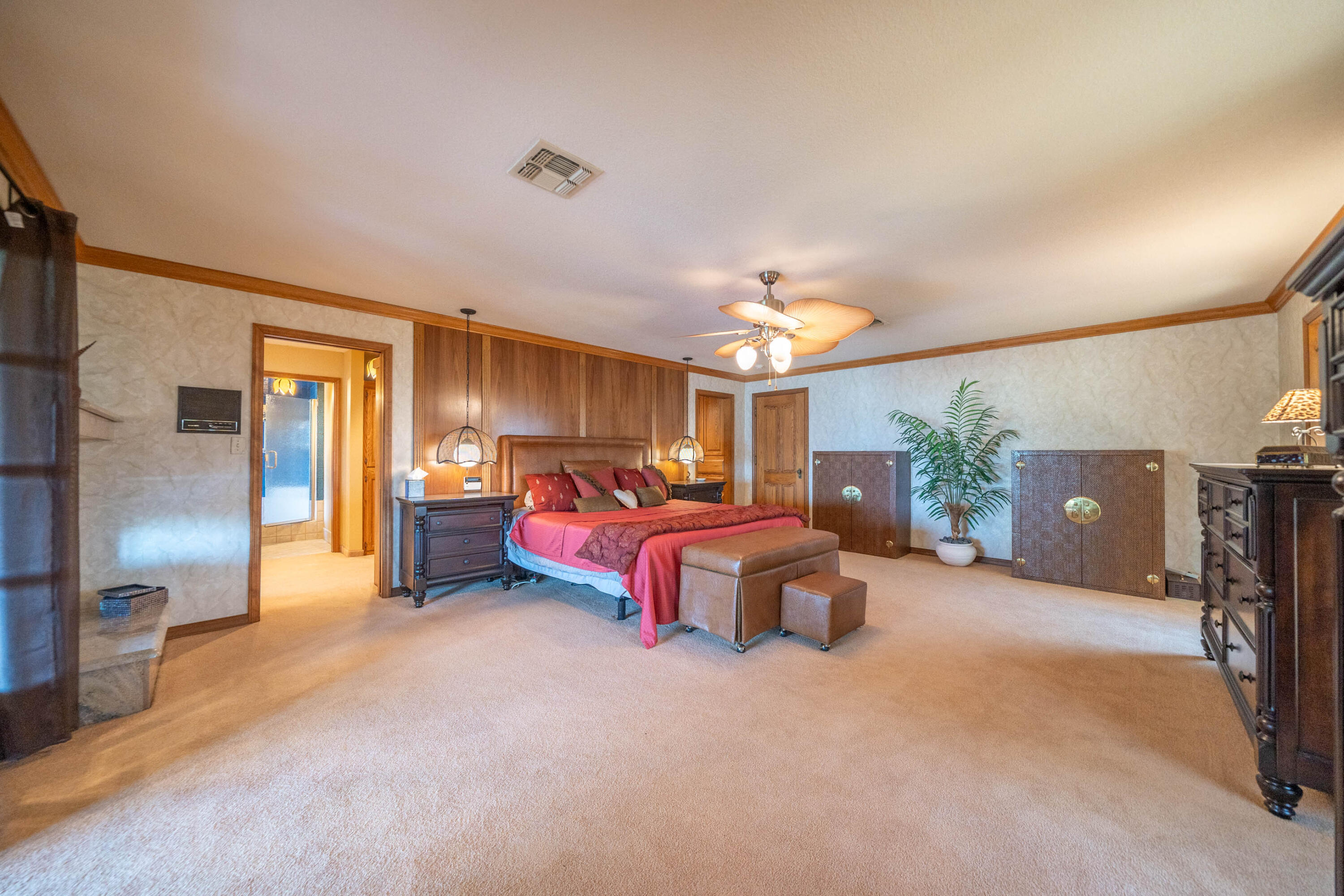 910 River Bend Road Redding, CA 96003 - Photo 70 of 92 a spacious bedroom with a bed and a chandelier