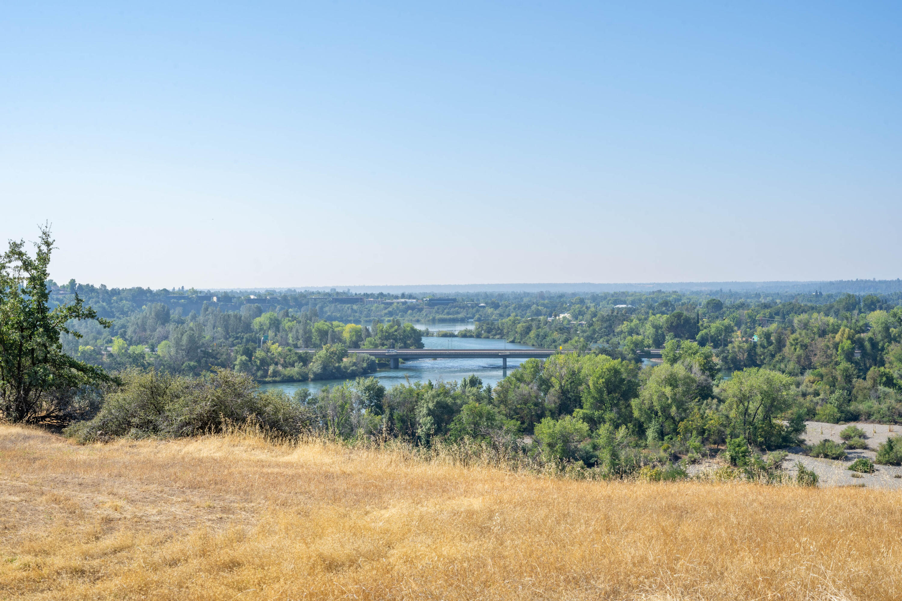 910 River Bend Road Redding, CA 96003 - Photo 7 of 92 a view of a lake with mountains in the background