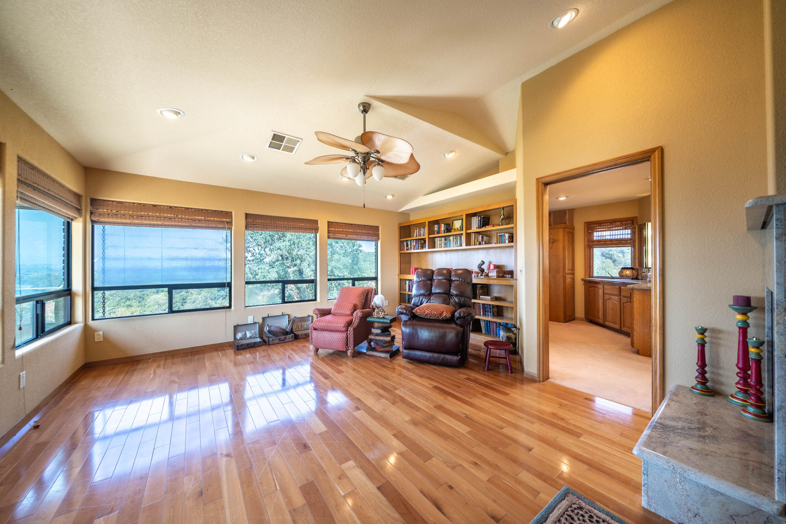 910 River Bend Road Redding, CA 96003 - Photo 72 of 92 a living room with furniture floor to ceiling window and a flat screen tv