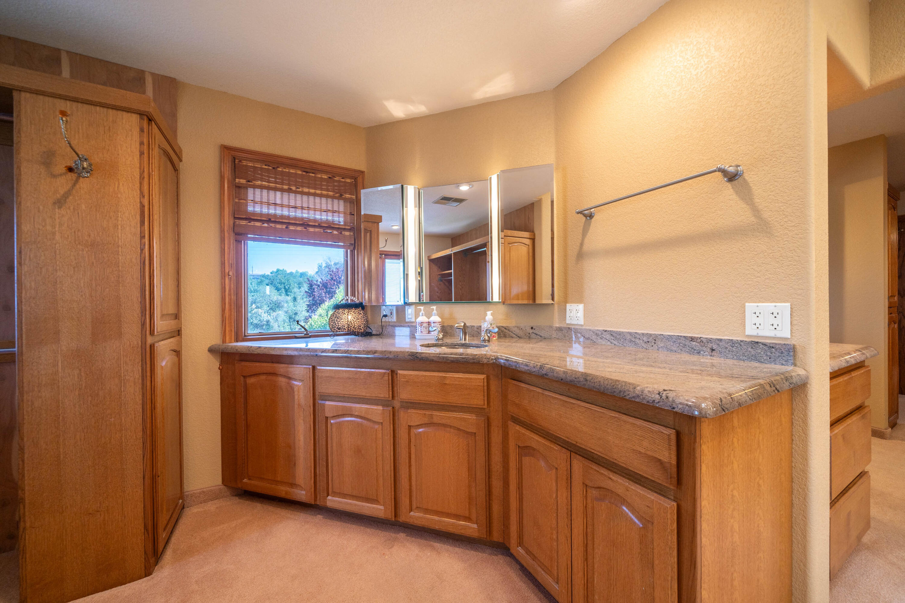 910 River Bend Road Redding, CA 96003 - Photo 76 of 92 a bathroom with a granite countertop sink and a mirror