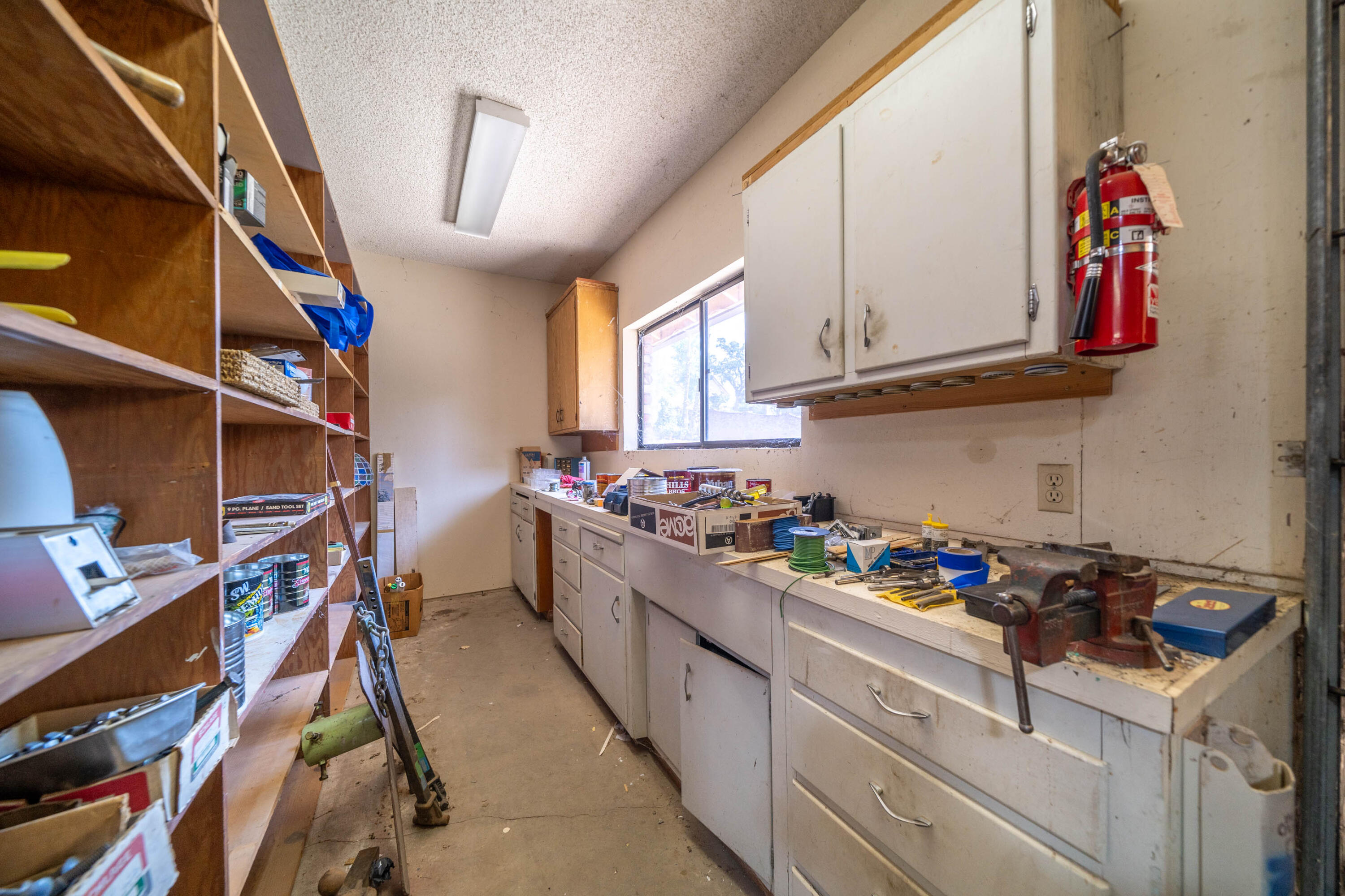 910 River Bend Road Redding, CA 96003 - Photo 84 of 92 a kitchen with granite countertop lots of clutter and stainless steel appliances