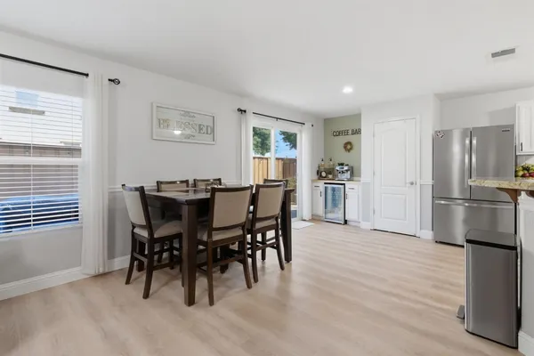 a view of a dining room with furniture and wooden floor