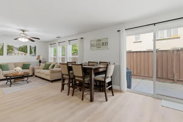 a view of a dining room with furniture and a large window