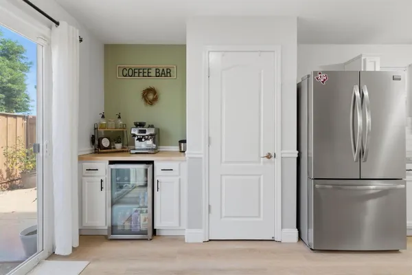 a view of kitchen with stainless steel appliances granite countertop cabinets and a refrigerator
