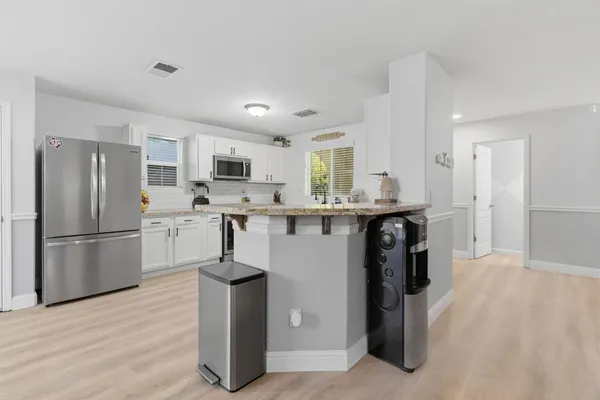 a kitchen with stainless steel appliances a refrigerator stove microwave and sink