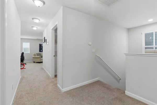 a bedroom with a bed desk and a window
