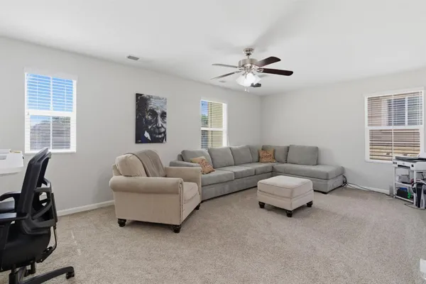 a living room with furniture and a chandelier