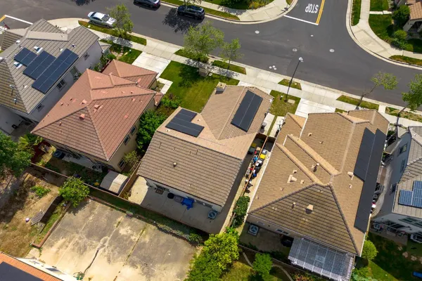 an aerial view of residential houses with city view