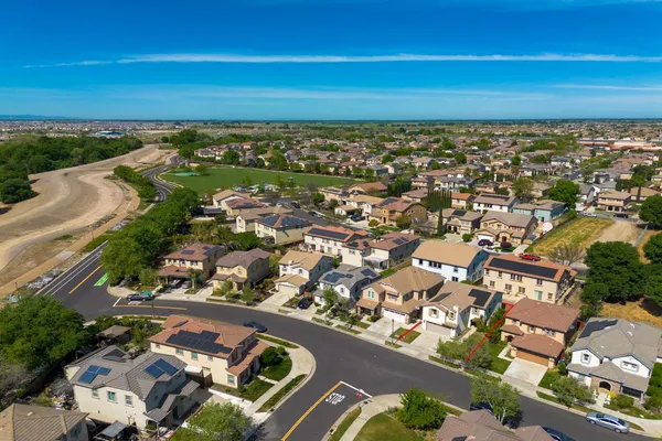 an aerial view of residential houses with outdoor space