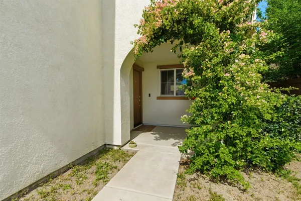 a front view of a house with a garden