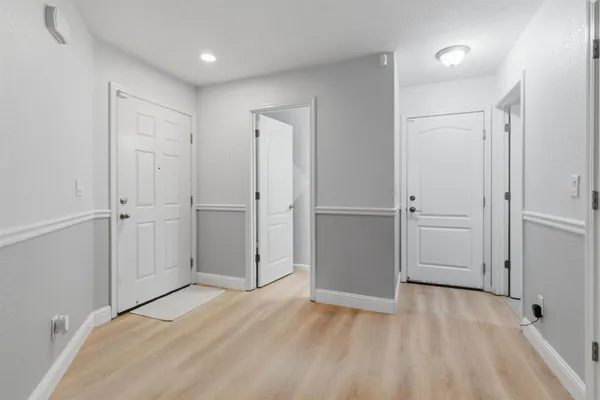 a view of empty room with wooden floor