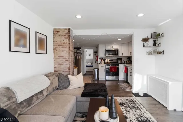 a living room with furniture and kitchen view