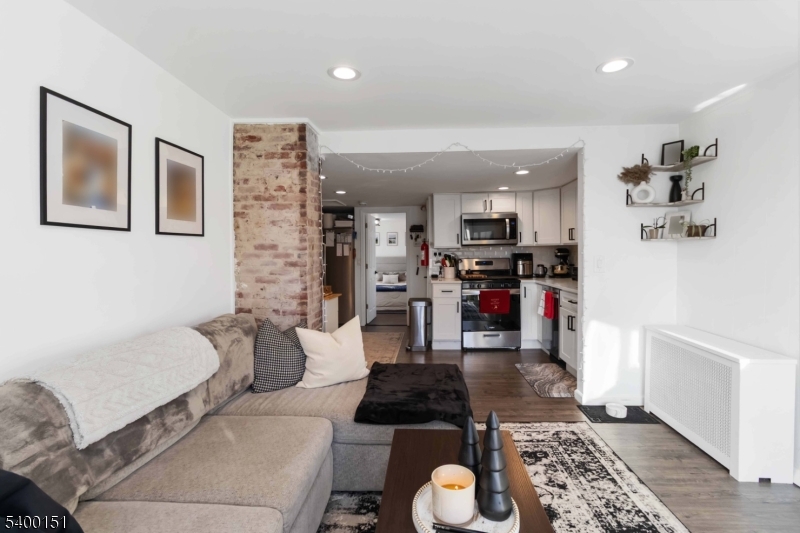 34 Ashwood Avenue, Unit 2 Summit, NJ 07901 - Photo 6 of 16 a living room with furniture and kitchen view
