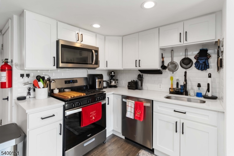 34 Ashwood Avenue, Unit 2 Summit, NJ 07901 - Photo 8 of 16 a kitchen with granite countertop a sink a stove and cabinets