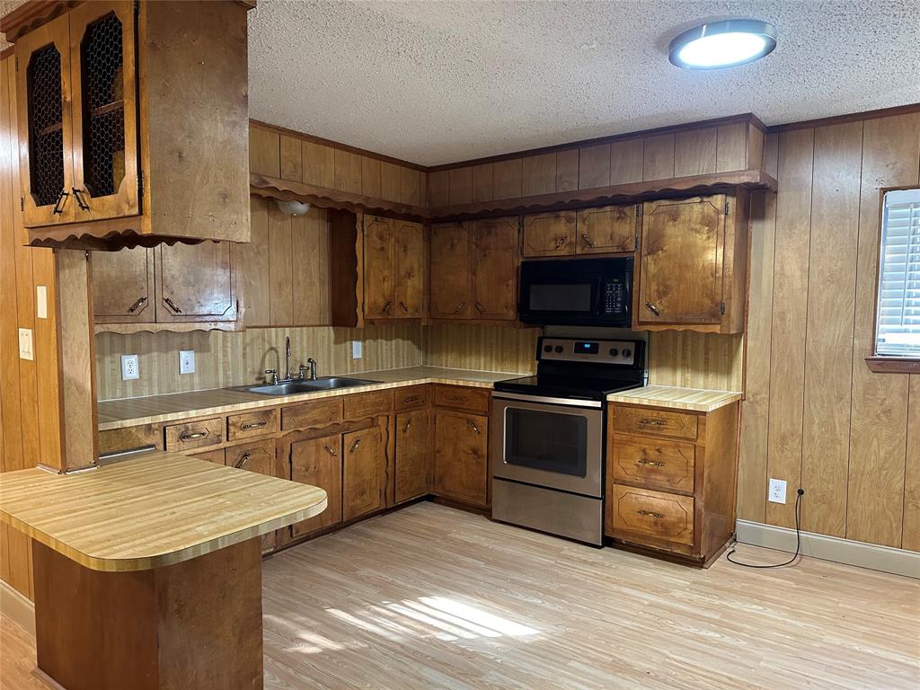 102 7th Street Celeste, TX 75423 - Photo 2 of 10 a kitchen with a sink stove and microwave