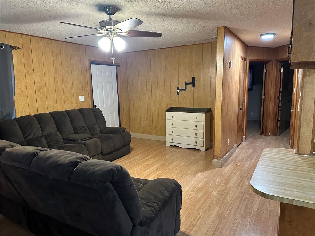 102 7th Street Celeste, TX 75423 - Photo 4 of 10 a living room with furniture and a ceiling fan