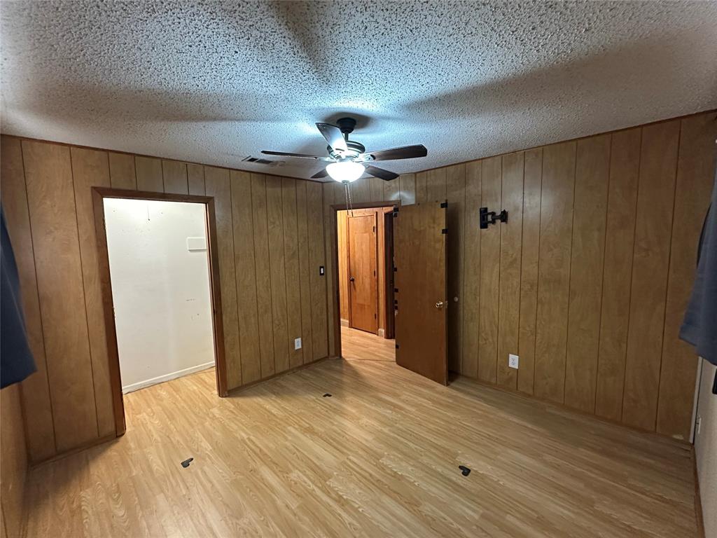 102 7th Street Celeste, TX 75423 - Photo 6 of 10 wooden floor in an empty room with a bathroom