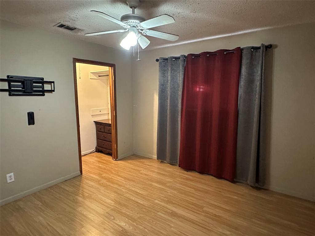 102 7th Street Celeste, TX 75423 - Photo 7 of 10 a view of a room with wooden floor closet and windows