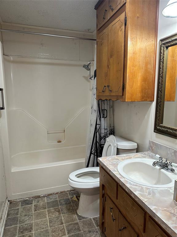 102 7th Street Celeste, TX 75423 - Photo 10 of 10 a bathroom with a granite countertop sink toilet and shower