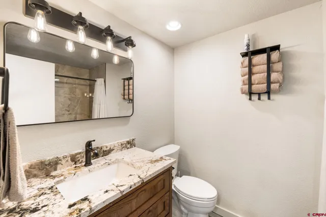 a bedroom with a bed and a night stand