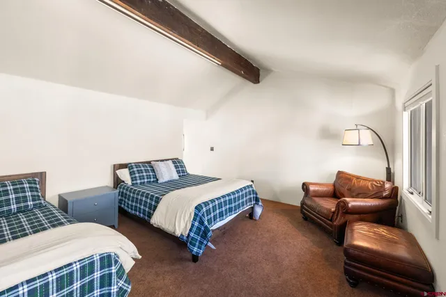 a bedroom with bed and a couch