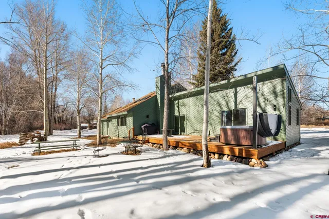 a view of a patio with a fire pit and chairs