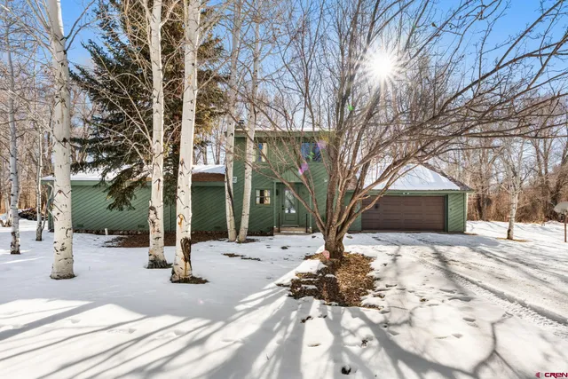 a large kitchen with cabinets table and chairs