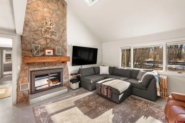a bathroom with a granite countertop sink vanity mirror and toilet