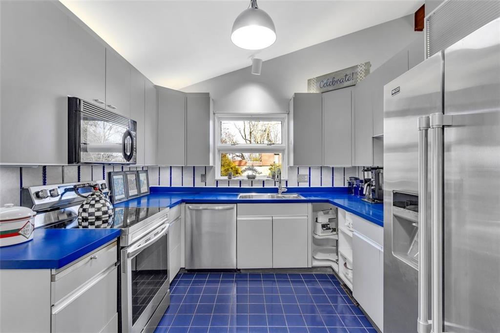 346 Churchill Road Pittsburgh, PA 15235 - Photo 11 of 40 a kitchen with stainless steel appliances a sink stove and refrigerator