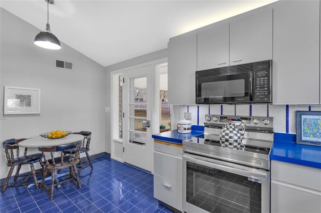 346 Churchill Road Pittsburgh, PA 15235 - Photo 13 of 40 a kitchen with stainless steel appliances kitchen island granite countertop a stove a sink and a microwave