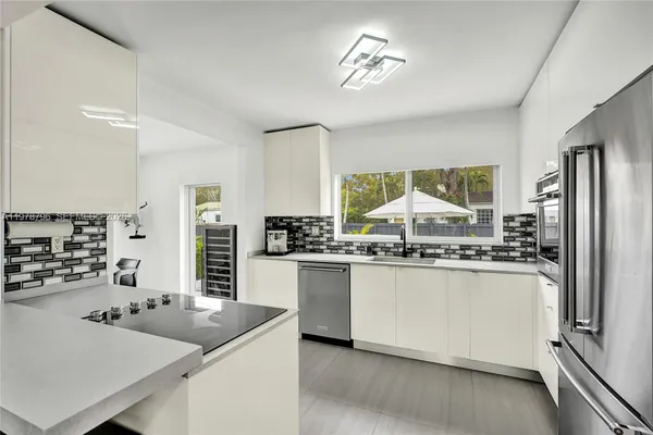 a kitchen with kitchen island granite countertop a stove and a refrigerator