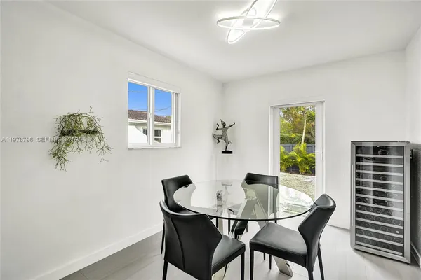 a dining room with furniture and window