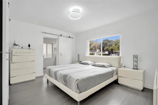 a bedroom with a bed and window