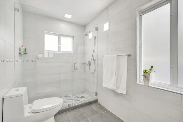 a bathroom with a shower and a toilet