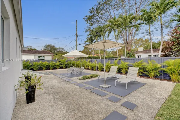 a view of a backyard with plants and patio