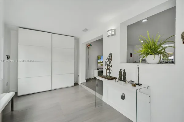 a room with two chair and white doors