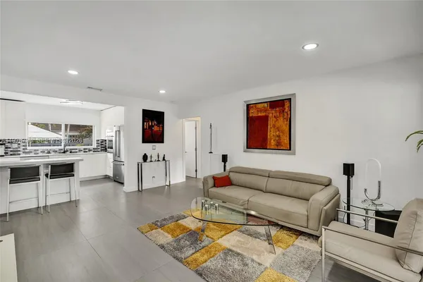 a living room with furniture and kitchen view