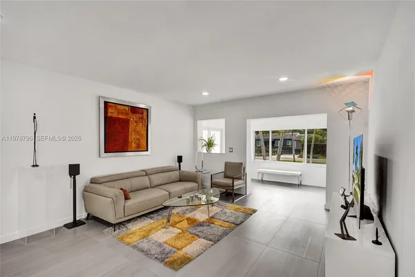 a living room with furniture and a flat screen tv