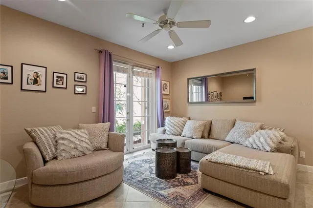 a living room with furniture and a chandelier