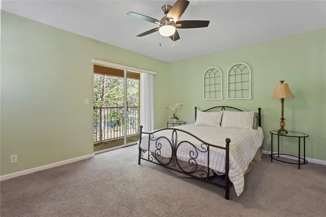 a bedroom with a bed and a large window