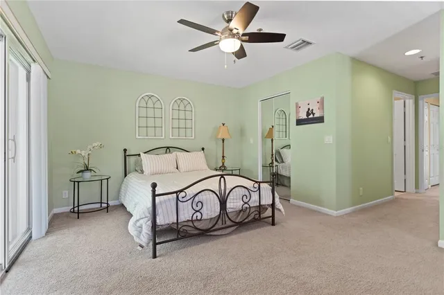 a bedroom with a large bed and a chandelier