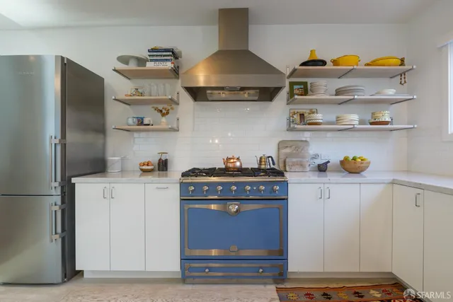 a kitchen with stainless steel appliances granite countertop a stove and a refrigerator