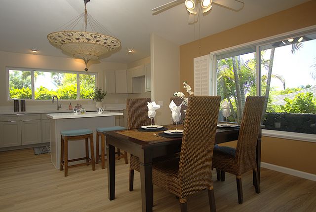 a dining room with furniture a chandelier and wooden floor