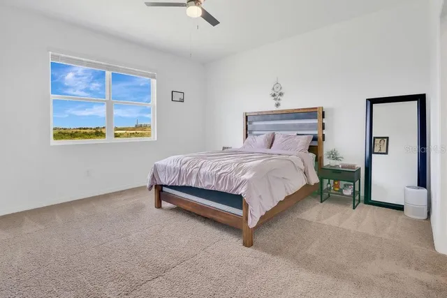 a bedroom with a bed and a window