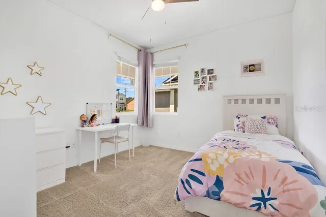 a bedroom with a bed and a table in it