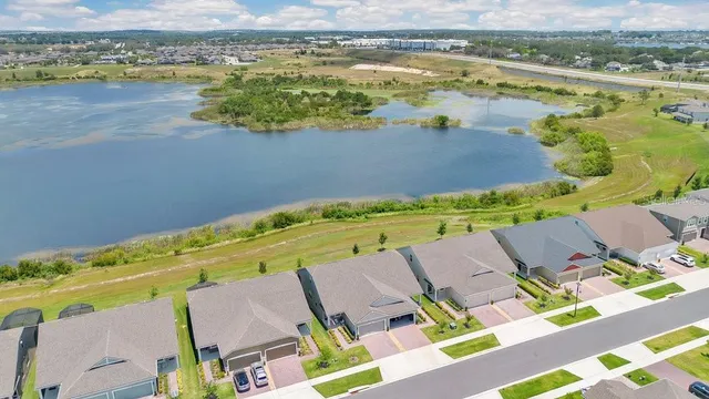 an aerial view of a house with a lake view