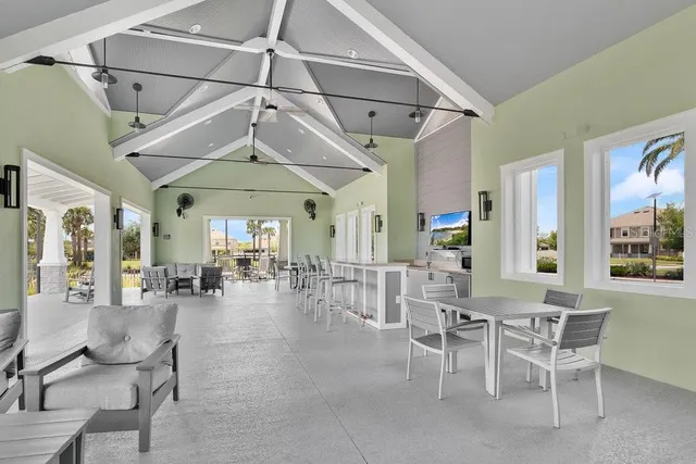 a dining hall with couches a dining table and chairs