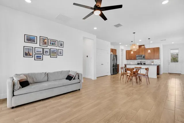 a living room with furniture and kitchen view