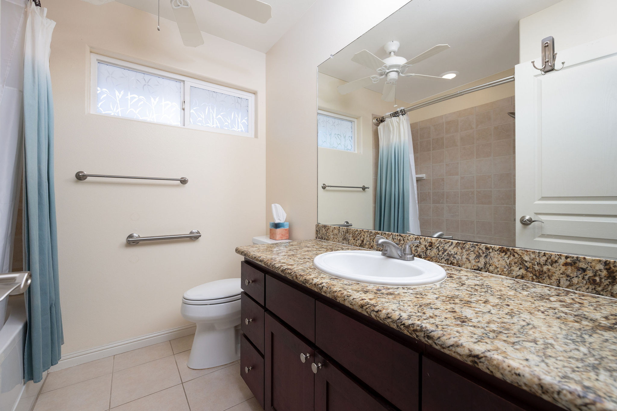 77-267 Hoomohala Road Kailua-Kona, HI 96740 - Photo 13 of 30 a bathroom with a granite countertop sink a toilet and a mirror