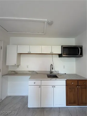 a bedroom with a bed and a night stand